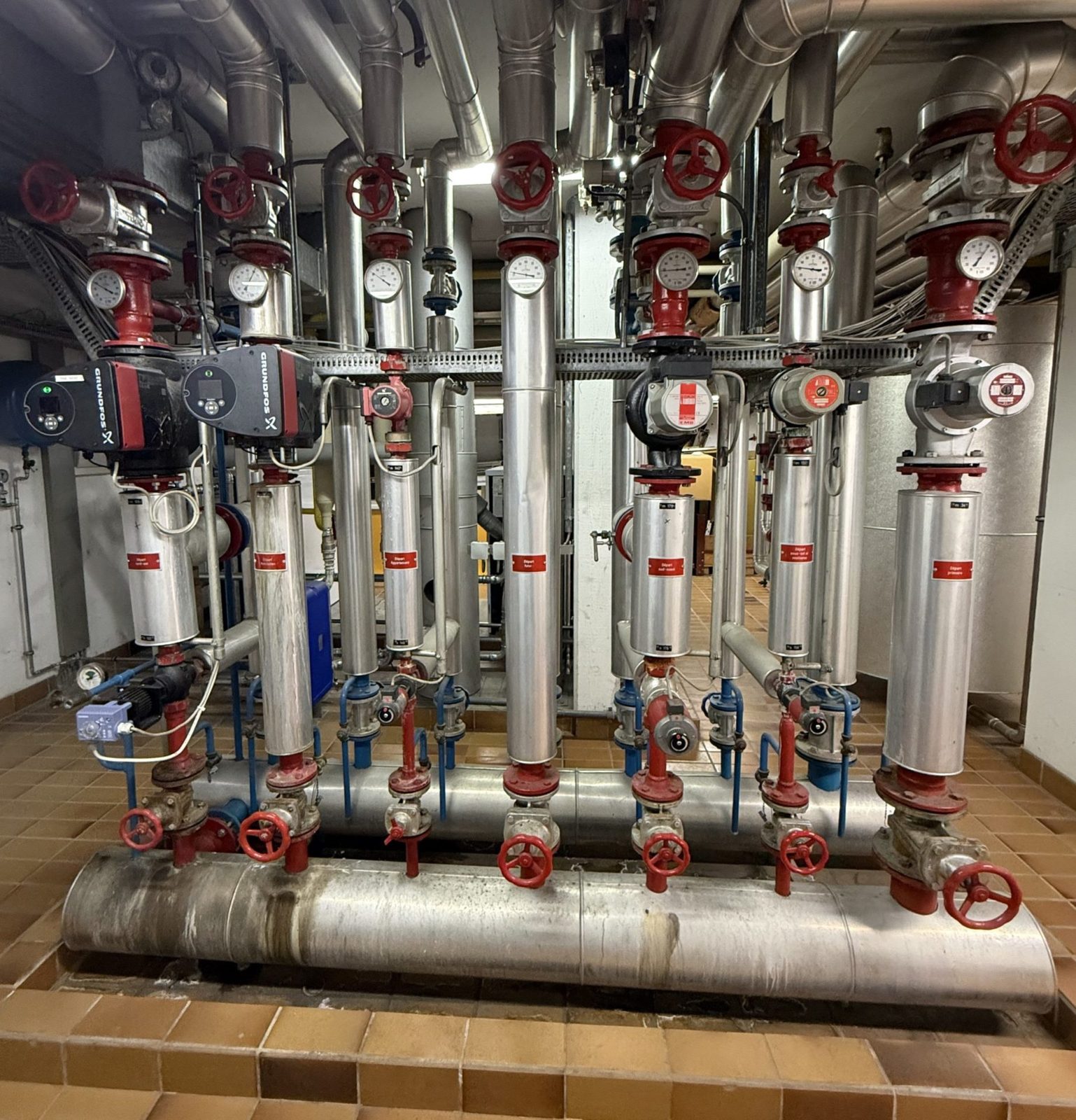 Plant room with pumps, valves and heating and ventilation pipework